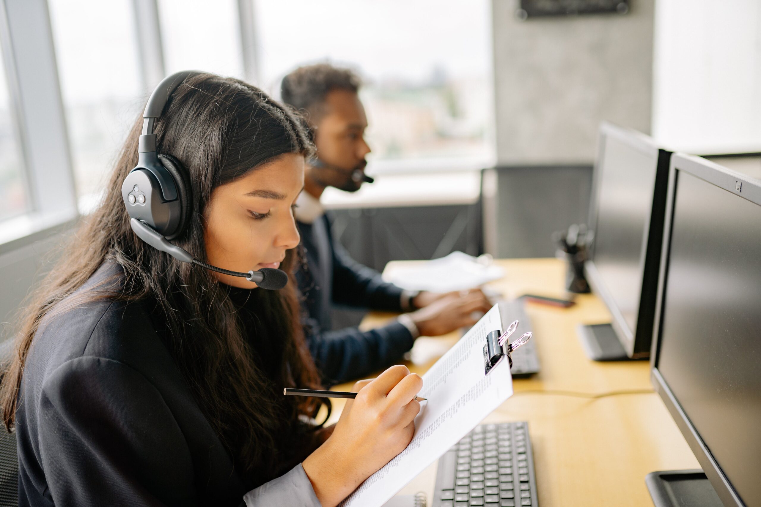 two people sat wearing headsets