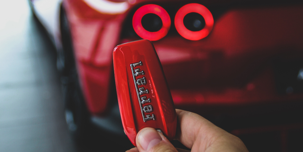 person holding red ferrari key 