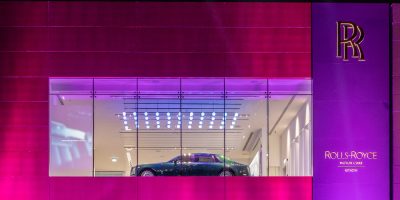 rolls royce show room lit in purple and pink