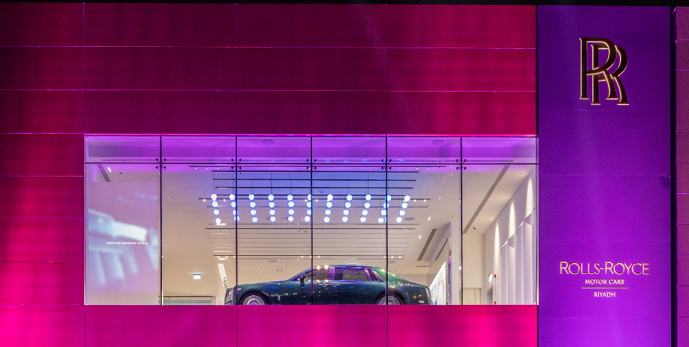 rolls royce show room lit in purple and pink